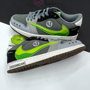 کتونی ترویس اسکات مانستر با طراحی خاص، لوگوی سبز مانستر و ترکیب رنگ جذاب مشکی و سفید.