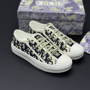 تصویر کتونی دیور سفید سورمه‌ ای با طراحی کلاسیک و جزئیات لوکس در ترکیب رنگ سفید و سورمه‌ای