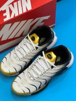 کتونی نایکی تی ان ایرمکس پلاس پریمیوم 50سالگی مشکی و سفید با جزئیات طلایی در پسزمینه روشن