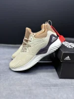 کتونی آدیداس آلفابانس بیاند کرم با مش کرم و زیره BOUNCE™ در پسزمینه روشن