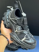 کتونی بالنسیاگا هایک مشکی با مش تیره و افکت کهنه در پس‌زمینه روشن