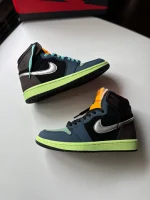 کتونی نایکی جردن 1 های توکیو بایو هک با سُئد براون و سووش متالیک در پس‌زمینه روشن